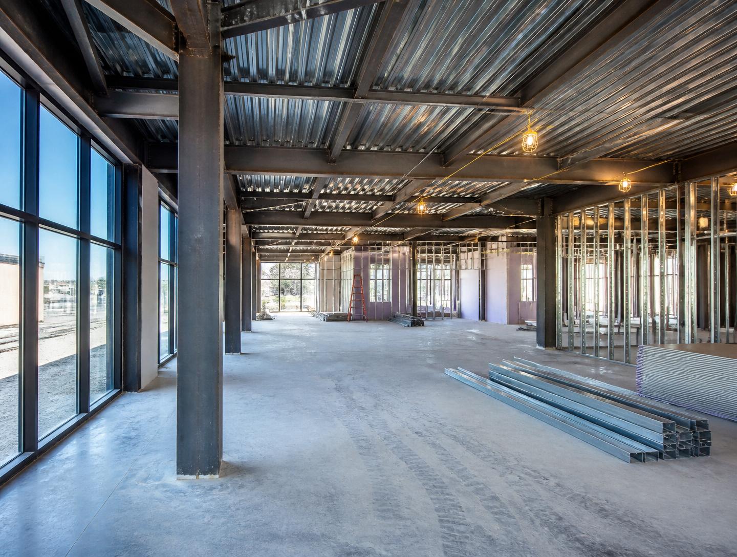 Interior of a commercial building under construction with exposed steel columns